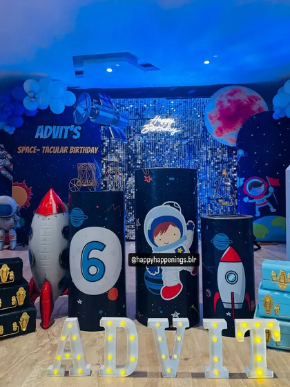 A closer look at the space-themed setup for Advit's birthday. We used marquee letters for his name, custom-printed plinths with astronaut graphics, and a neon sign to light up the galaxy.