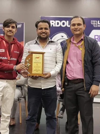 One of our coaches being honored as a guest at the Bharat League, receiving a plaque for his contributions to the sport.