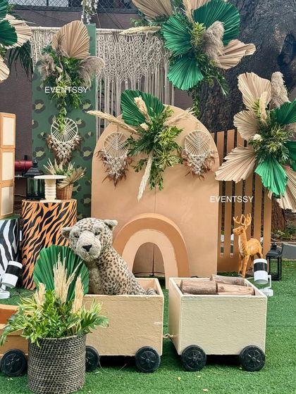 This shot highlights the use of different textures, from animal print pedestals to dried pampas grass and a macrame wall hanging.