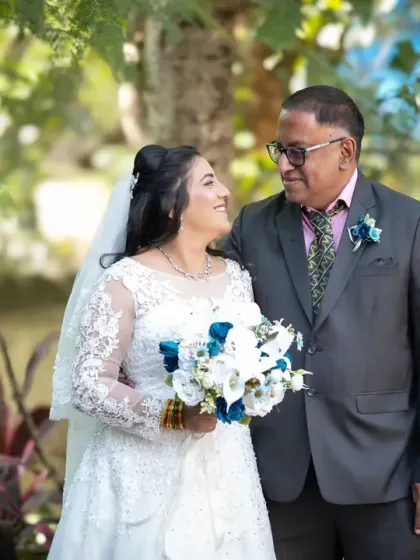 A precious moment between the bride and her father. His proud smile and her happy expression make this a photo to cherish forever.
