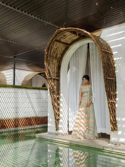 A moment of quiet beauty at the Taj Bekal. I used the unique architecture of the resort, with its woven archways and tranquil water features, as a stunning backdrop for this bridal portrait.