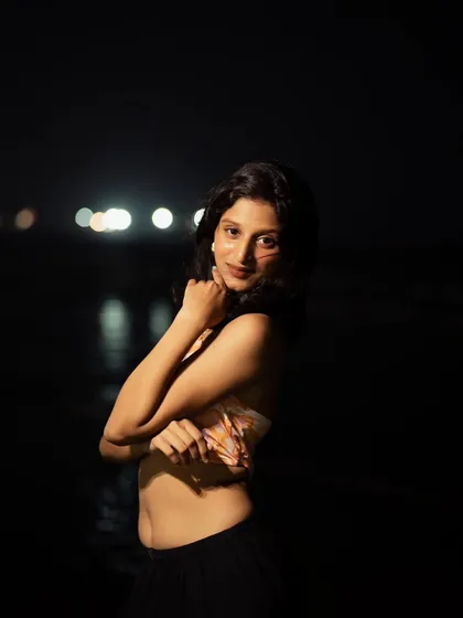 This pose is both confident and relaxed. Night photography allows for a focus on expression and mood, perfect for creating compelling influencer content.