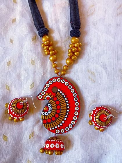 The same 'kalka' motif necklace, in a classic red and gold combination.