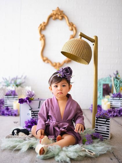 A serious model look from this little one in her purple spa robe.