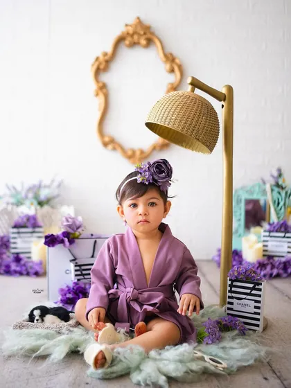 A serious model look from this little one in her purple spa robe.