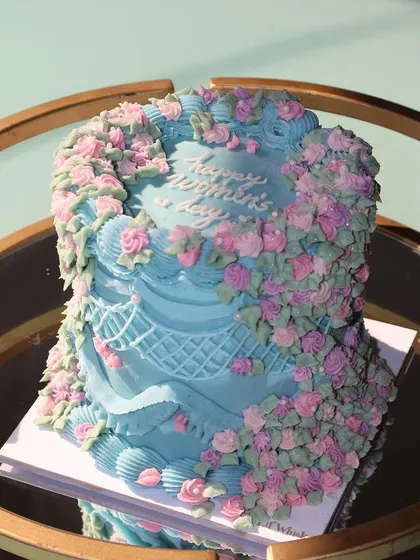 Another angle of our beautiful floral cake for Women's Day, showcasing the intricate lattice piping work on the side.