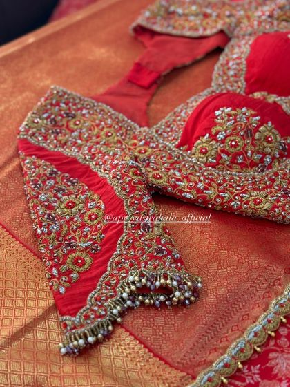 A close-up of the sleeve detail on the red bridal blouse.