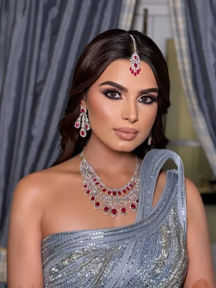 Another stunning portrait of Kanu. The makeup is designed to be bold and captivating, perfect for a night of celebration.