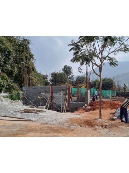 The construction site at Nandi Hills, with piles of granite off-cuts ready to be used for the load-bearing walls. The project is deeply tied to its material landscape.