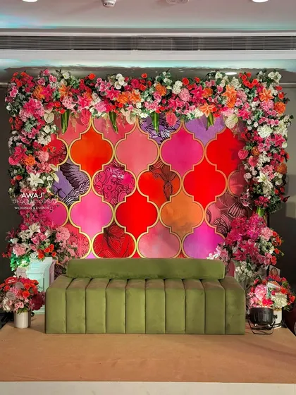 A straight-on shot of the beautiful and colorful Mehendi stage, a perfect throne for the bride-to-be.