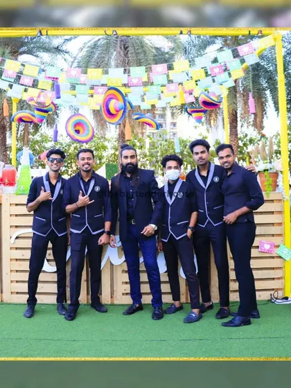 Suited up in all black for a carnival-themed event. This sleek, uniform look adds a touch of class and mystery to the festivities.