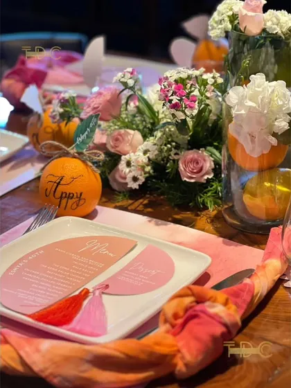 Every place setting was personalized with custom menus and name tags written on actual oranges, adding a unique and fragrant touch to the citrus-themed decor.