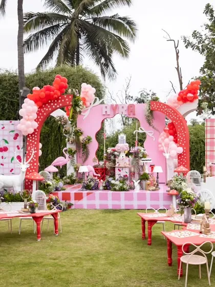 A whimsical wonderland in pink and red for a 'Blossoms & Bows' themed birthday. This overview shows how I combine large-scale backdrops, themed seating for children, and playful props to create a cohesive and enchanting party space.