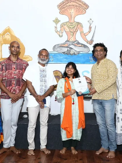 A young graduate proudly receives her certificate, showing that the path of healing is open to all ages.