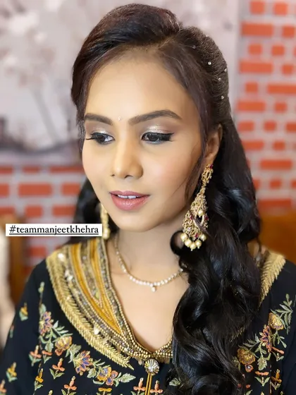 This client looks radiant and happy, ready for the ceremony. The subtle glitter on her eyes catches the light beautifully, and the nude lip keeps the look balanced and sophisticated.