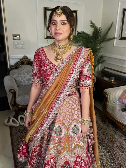 A look so divine, it feels like a blessing from the past. This bride's makeup is soft and timeless, complementing her colorful and traditional lehenga.