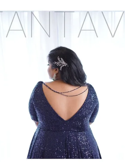 It's all about the details. This classy navy blue sequin gown features a deep V-back, elegantly accented with delicate beaded chains for a touch of glamour, perfect for a cocktail night or reception.