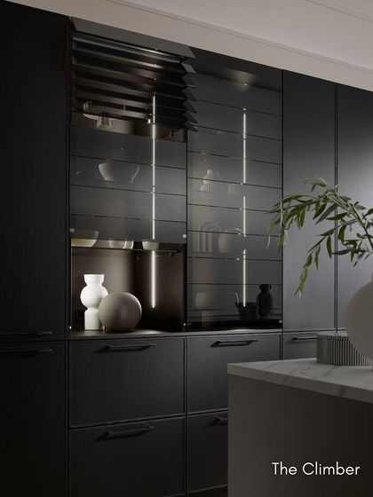 The "Climber" cabinet with its sensor-controlled glass slats. The tinted glass and ambient lighting create a dramatic display feature for your finest glassware.