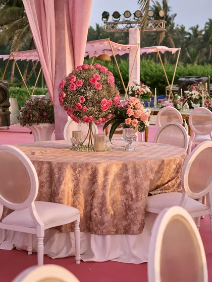 Guest seating at the Goa beach wedding. I used elegant tables with textured pink linens and floral centerpieces to continue the romantic theme, ensuring every part of the setup felt cohesive.