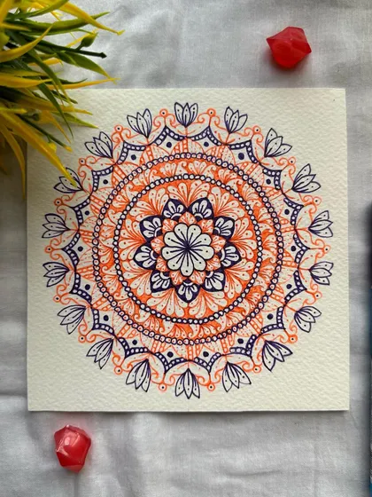 I love the striking combination of orange and purple in this piece. The colors are bold and confident, creating a mandala that is both simple in its structure and significant in its impact.