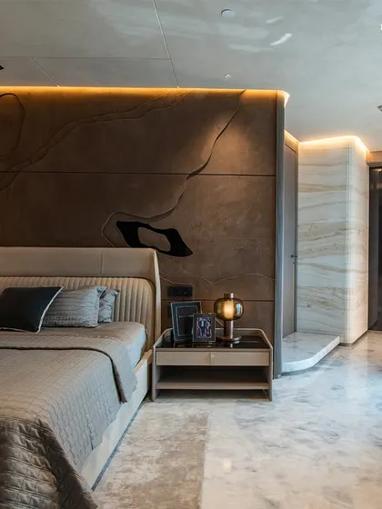 This bedroom at Lodha Worldview harmonizes elegance and luxury with a carefully selected palette of materials. A custom wall mural in fiery reds and oranges injects energy, while soft furnishings and ambient lighting set an inviting yet indulgent tone.