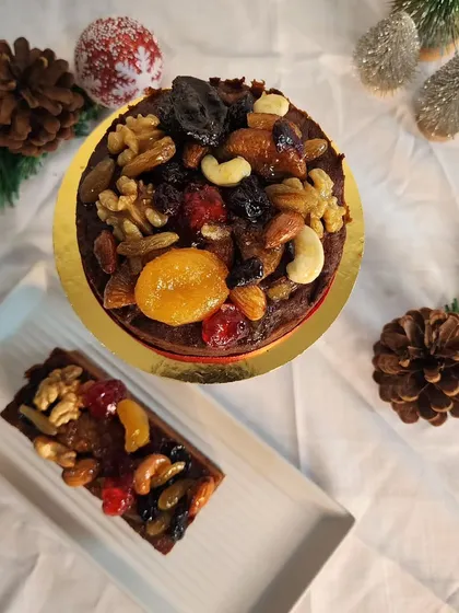 A top-down view of my festive fruit cake, showing the generous topping of assorted dry fruits and nuts.
