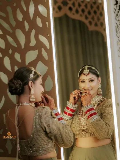 The bride getting ready for her big day, with her beautiful mehendi adding to her overall look.