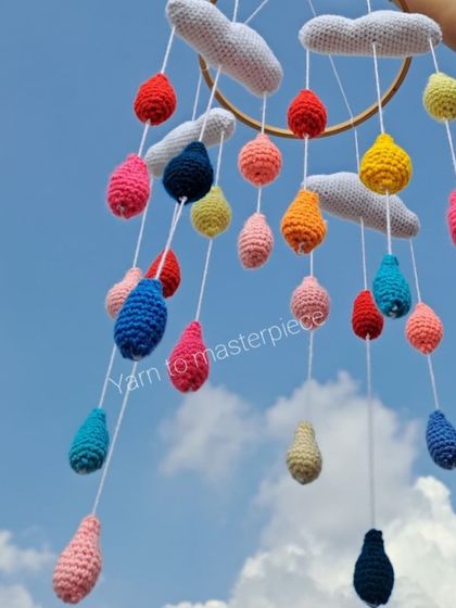 My cloud and raindrops cradle hanging is perfect for a peaceful nursery. Soft grey clouds hang above a shower of colorful raindrops, creating a beautiful visual for your little one.
