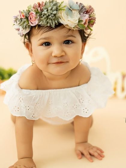 A confident crawl towards the camera. This one-year milestone session with a floral crown and soft colors is simply enchanting.