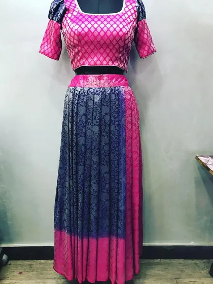 This is an example of how I can turn an old saree into a new lehenga set. I used the saree's fabric to create a pleated lehenga skirt and a matching brocade blouse for a completely new outfit.