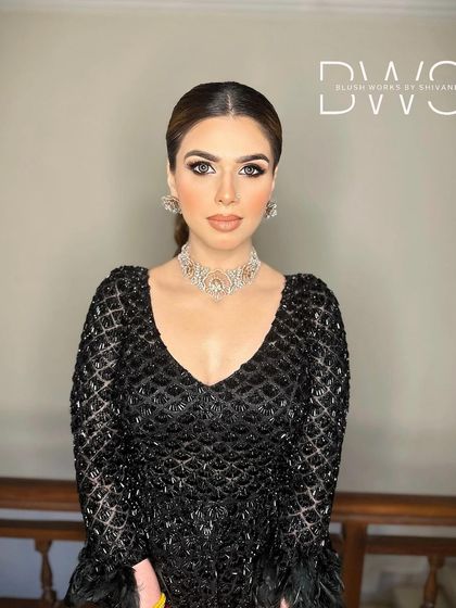 A front view of the client, her high ponytail creating a sophisticated and powerful silhouette. This look is perfect for making a statement.