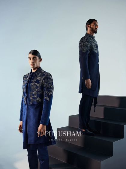 Couture that redefines regal grace. These deep blue jackets, one with shoulder embroidery and the other with an embellished front panel, offer two distinct takes on evening elegance.