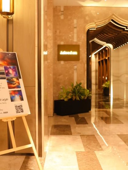The entrance to the 'Mystic Mirage' exhibition at JW Marriott, with a welcome stand featuring the show's dramatic artwork.