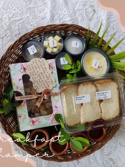 Our signature Malai Toast breakfast hamper, featuring thick slices of bread ready for toasting, homemade malai, butter, and our special chai masala, all presented in a beautiful basket.
