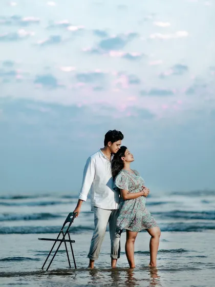 Using a simple prop like a chair can add a unique, artistic touch to a beach pre-wedding shoot, creating a story-like image against the vast ocean.