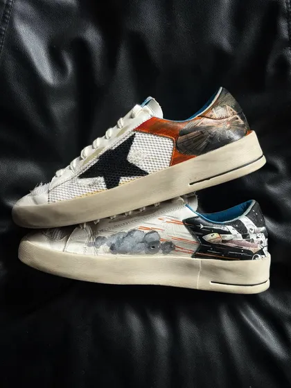 A pair shot of the custom-painted Golden Goose sneakers.