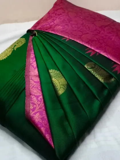 The classic combination of dark green and pink on this silk saree is always a winner. The pleats are set to highlight the gold motifs.