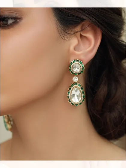 Elegant drop earrings featuring two polki diamonds framed by vibrant green enamel, a classic design with a pop of color.