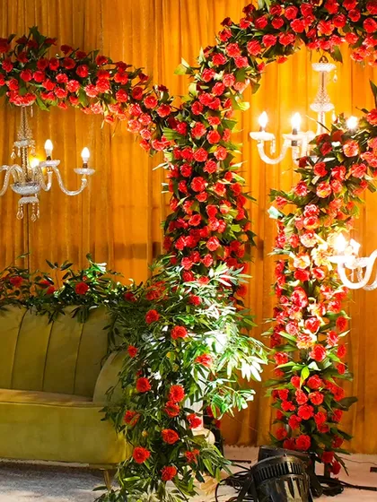The rich texture of red roses against a golden backdrop. This detailed shot highlights the quality and artistry of our floral arrangements, which are central to creating a luxurious feel.