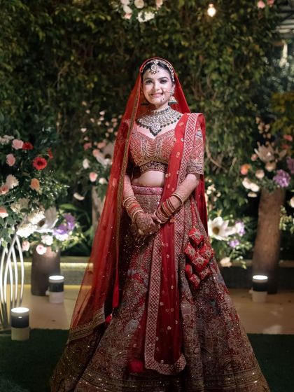 A smiling bride stands confidently in her wedding attire, ready for her big day. A perfect, classic bridal portrait.