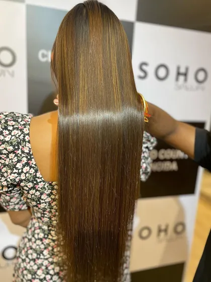 Another angle showcasing the sleek, polished finish from the hair botox and global highlights service. The light reflection demonstrates the health of the hair.