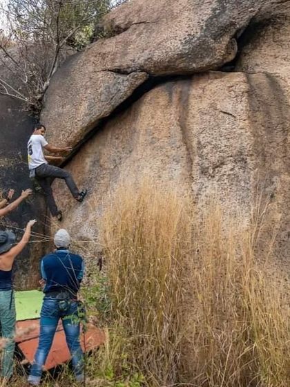Anand bouldering with spotters at the ready. This shows the importance of teamwork and trust, even when you're not on a rope.