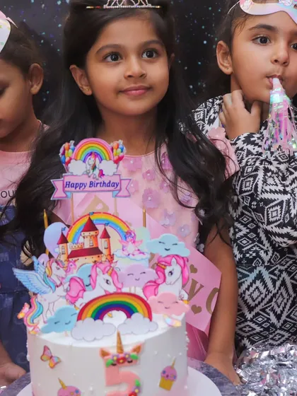 A beautiful unicorn and rainbow-themed birthday cake, ready for the big moment. I can help arrange cakes that perfectly match your chosen party theme.