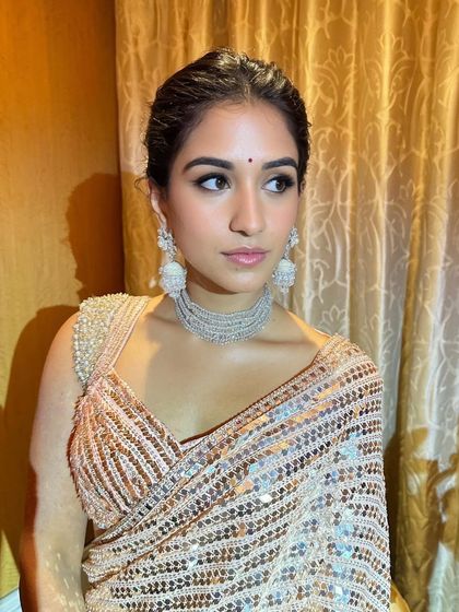The final look for Radhika Merchant's festive appearance. Her skin looks flawless and dewy, with a subtle bindi completing the traditional yet modern aesthetic. It’s a testament to how glam can still feel light and authentic.