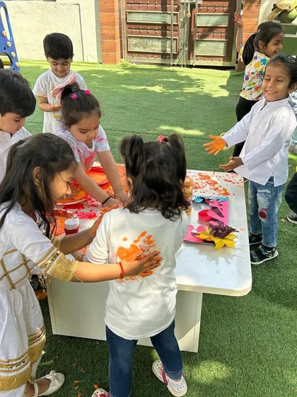 Friends celebrating Holi together. We encourage gentle and playful celebration, where children can enjoy the colours and festivities in a comfortable and supervised environment.