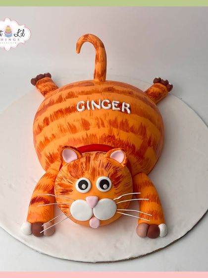 A purr-fectly adorable cake for a cat lover. This custom-shaped cake is designed to look like a playful ginger cat named Ginger.