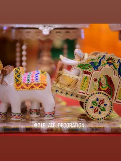 A charming and traditional prop of a bullock cart. These handcrafted items add an authentic, rustic touch to my decorations for events like housewarmings and baby showers.