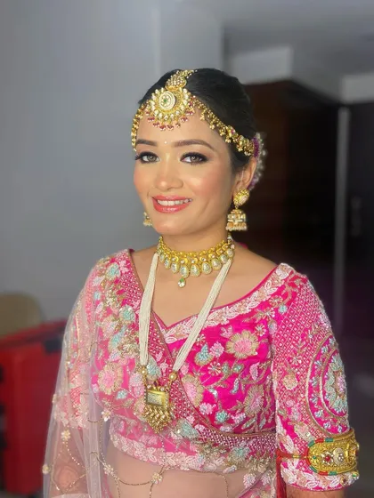 A classic bridal portrait of Pooja, looking radiant and ready for her wedding ceremony.