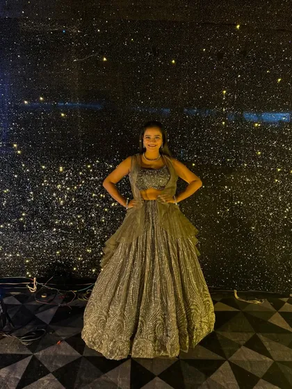 Posing against a starry, glittering backdrop at a Sangeet night. The theme was 'Glitz and Glam', and every detail was designed to make the night shine.