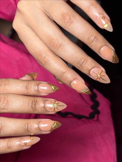 A candid shot showing how these stunning gold chrome nails look in natural movement.